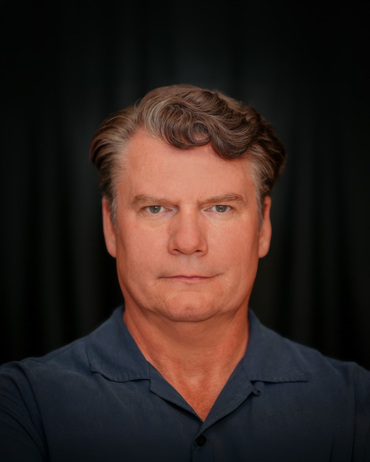 Dramatic theatrical actor headshot on a dark backdrop in Las Vegas