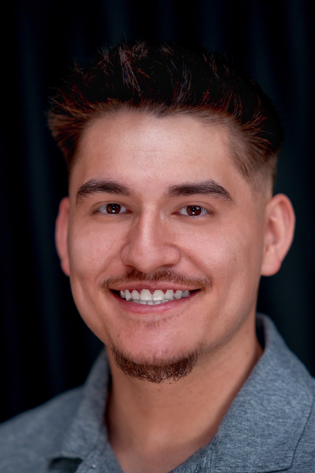 Actor headshot with a natural smile on a dark backdrop in Las Vegas